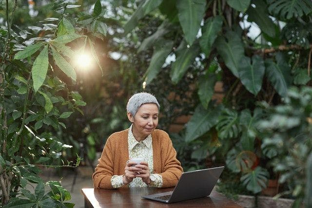 woman with laptop in a garden
